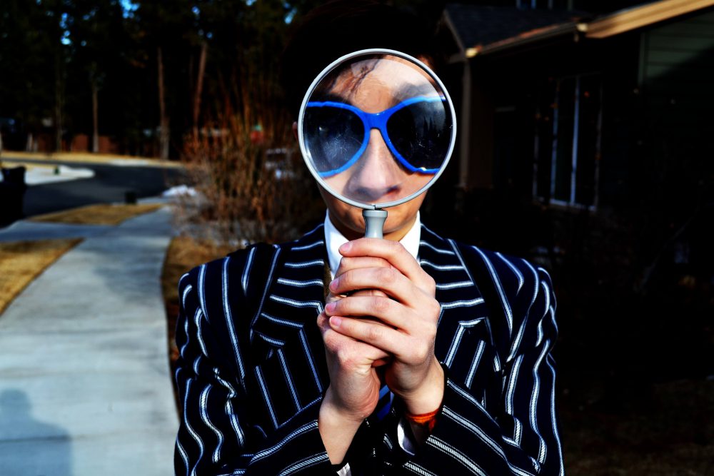 man looking through a magnifying glass