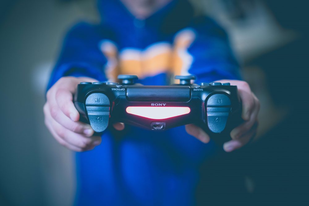 hands holding a gaming console